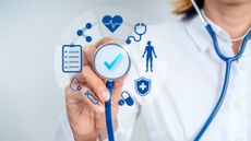 Doctor holding stethoscope with healthcare icons, representing annual health checkup