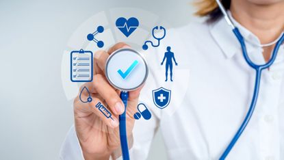 Doctor holding stethoscope with healthcare icons, representing annual health checkup