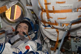 Japan Aerospace Exploration Agency astronaut Aki Hoshide, Expedition 33 flight engineer, attired in a Russian Sokol launch and entry suit, conducts a standard suit leak check in the Soyuz TMA-05M spacecraft in preparation for his return to Earth scheduled