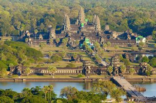 Aerial view of Angkor Wat, showing the moat and causeway and the central tower surrounded by four smaller towers