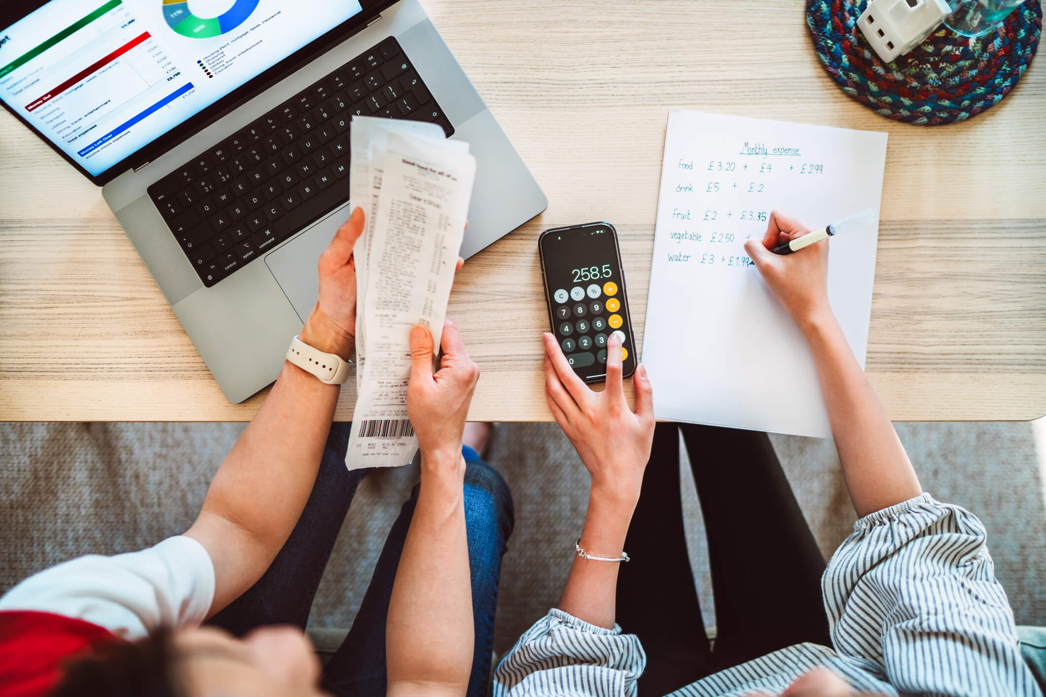 A direct above shot of a mother and her daughter working together to manage their household budget.