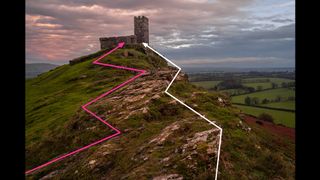 Church on a hill with pink and white arrows indicating leading lines, all beneath a pink sunset