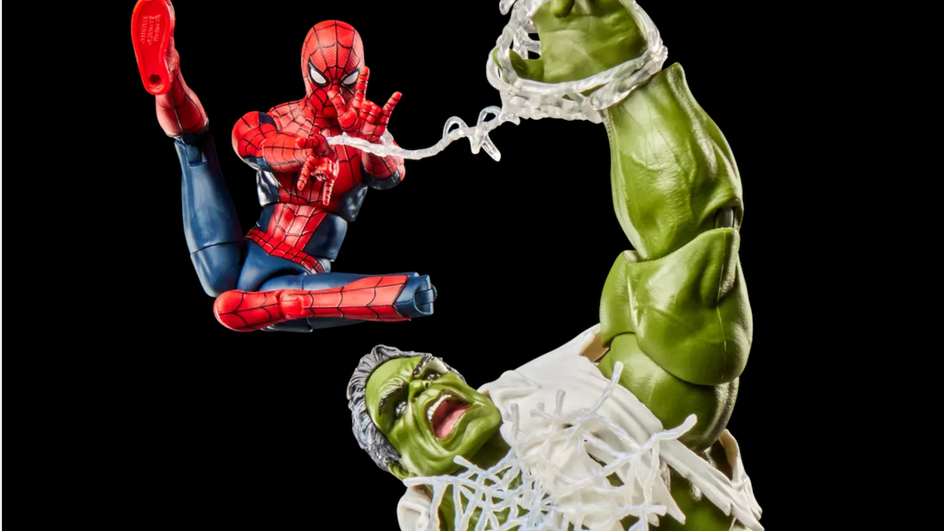 Spider-Man action figure fires webbing at Hulk against a black background