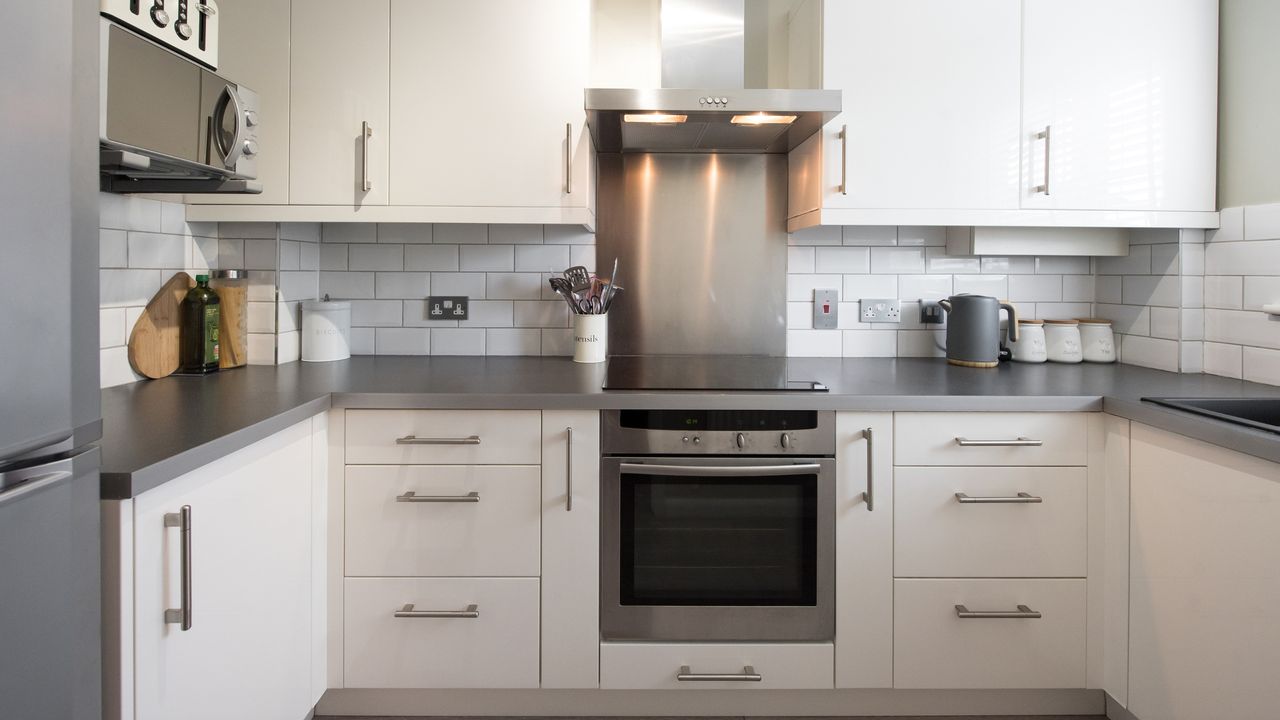 Small white kitchen with steel appliances