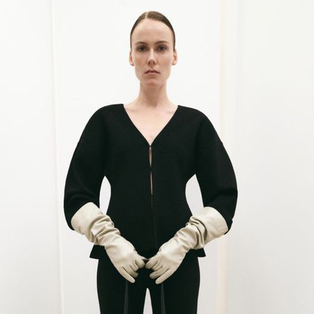 Model wears Mango cardigan with cream gloves