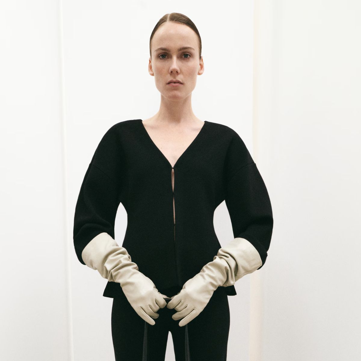 Model wears Mango cardigan with cream gloves 