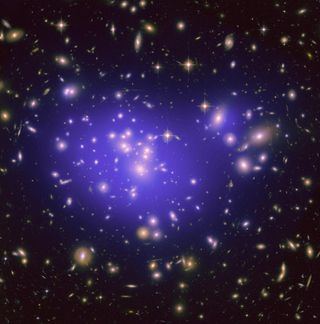 an image containing lots of galaxies, there is a hazy purple glow surrounding those in the center of the image, this halo represents dark matter.