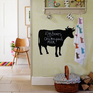 wallpaper on wall with cow shaped and blackboard on wall