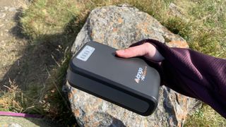 Hiker's hand holding Vango powerbank