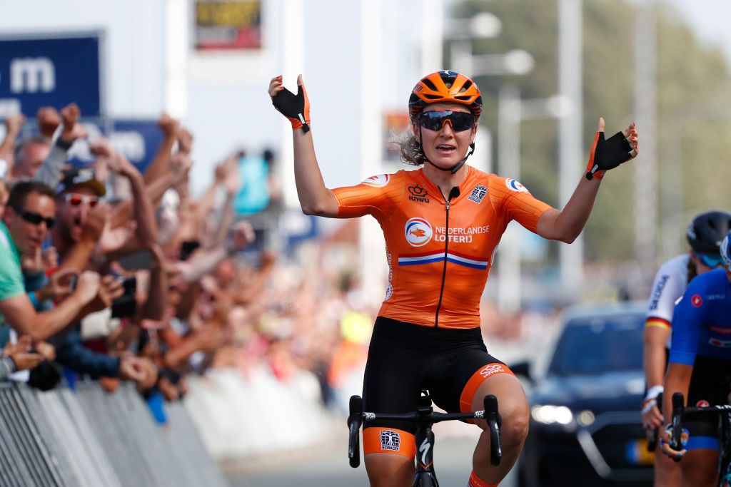 Amy Pieters sits up and celebrates