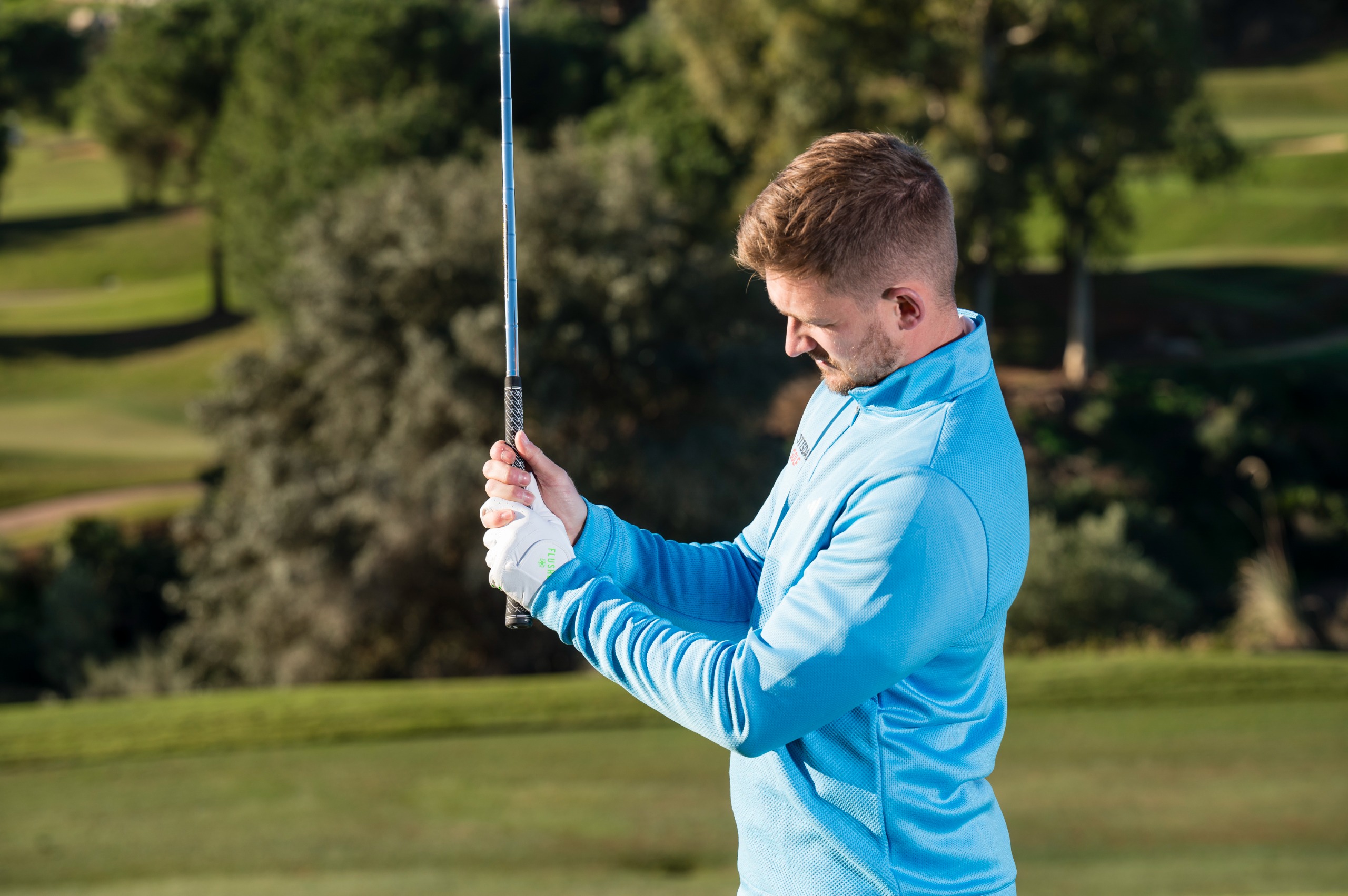 Alex Elliott demonstrating the correct right hand position on the golf club, with the grip running again through the fingers with an interlock visible