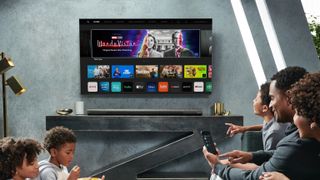 The Vizio P-Series Quantum X hangs on wall in front of family