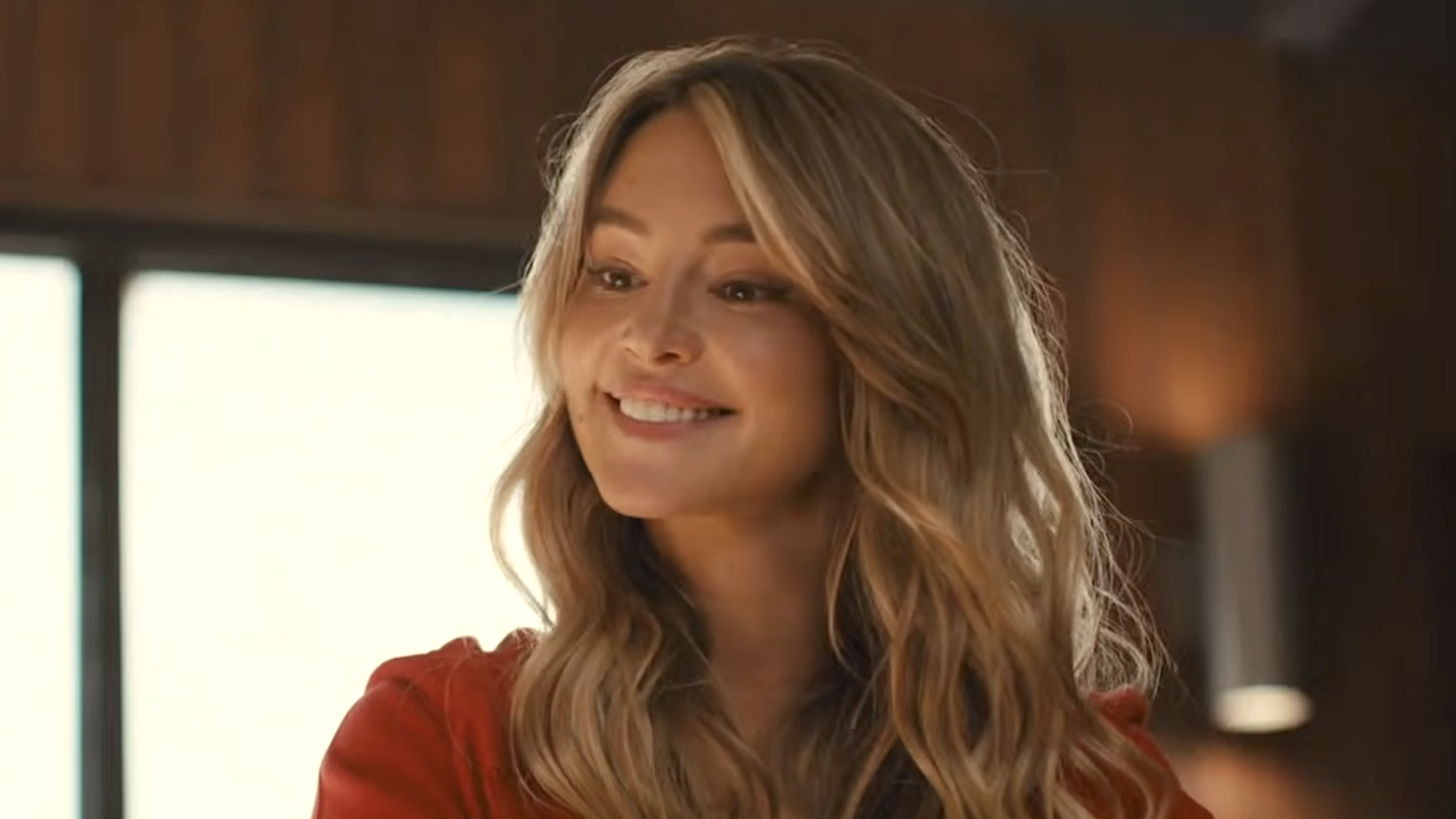 Hassie Harrison's Nat smiling in office in Baywatch 2027