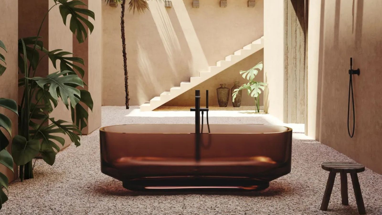 Outdoor bathroom with plaster walls, terrazzo flooring and amber glass bath in the center