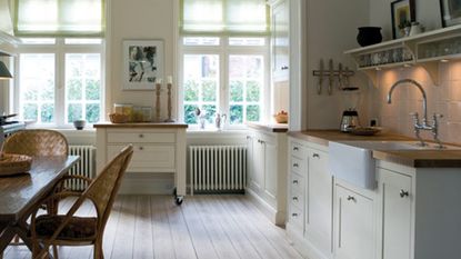 white kitchen with drawers and dining table