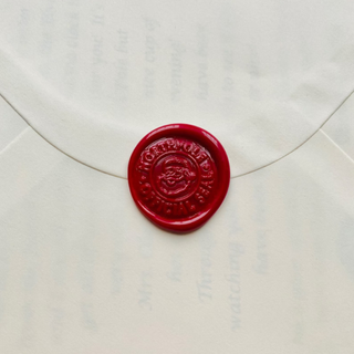 Red santa wax seal on white envelope