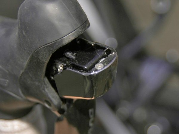Shimano use an annoying cover plate that must be removed in order to adjust reach or replace the brake cable