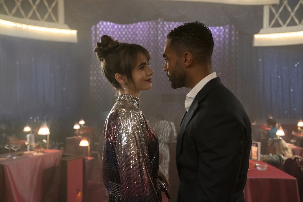 Emily in Paris L to R Lily Collins as Emily Lucien Laviscount as Alfie in episode 303 of Emily in Paris Cr Stphanie BranchuNetflix 2022