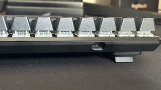 Corsair K65 Pro Mini RGB back showing USB-C connection port and ergonomic adjustable feet