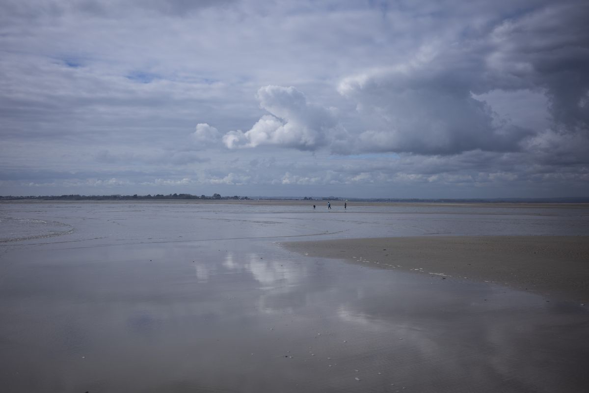 A beach with clouds overhead