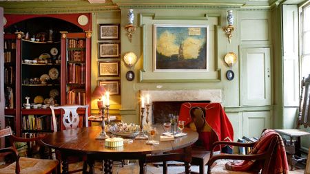 Georgian restored living room with candles and bookshelves and central table