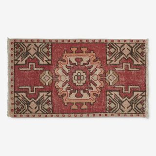 A red and beige vintage rug from Lulu and Georgia