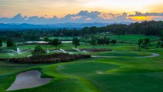 A Thai golf course seen from above at sunset