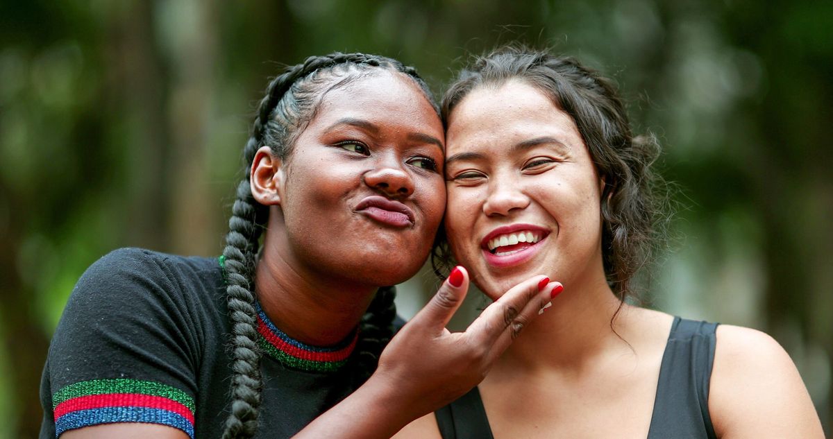 A portrait of two people laughing, with acne retouched in the Lightroom mobile app