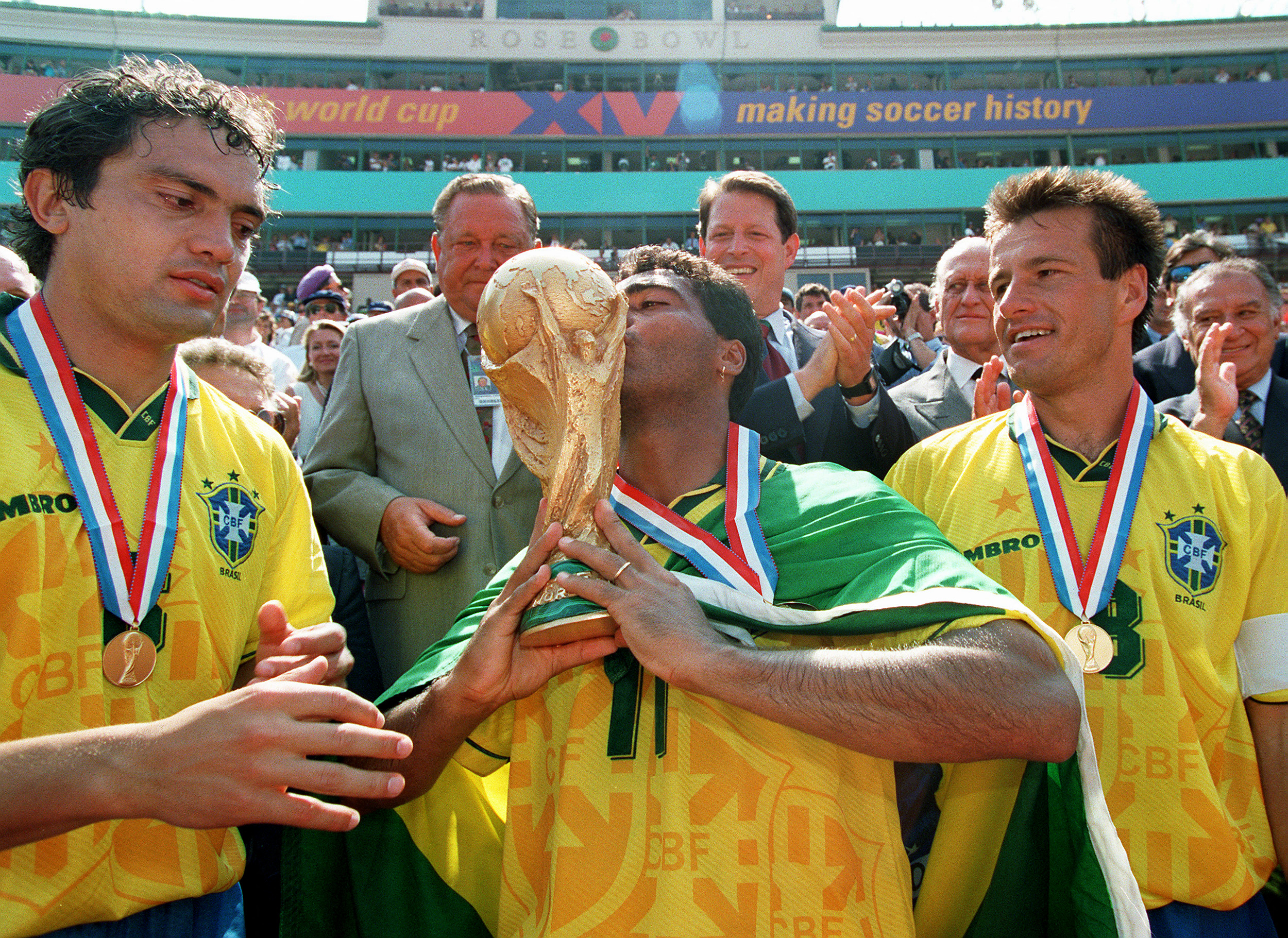 Romario (centre) kisses the World Cup trophy alongside Branco (left) and Dunga after Brazil's win on penalties against Italy in the 1994 final.