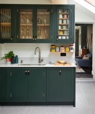 Dark kitchen with glazed wall cabinets