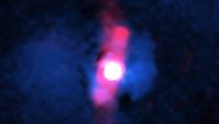 A blurry pinkish red circle surrounded by two jets of pink light.