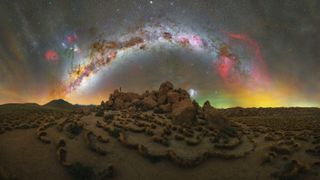 Milky way arc photographed above a mound of rocks in Atacama Desert, Chile