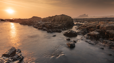 Sunrise over Bamburgh Castle on the Northumberland coastline