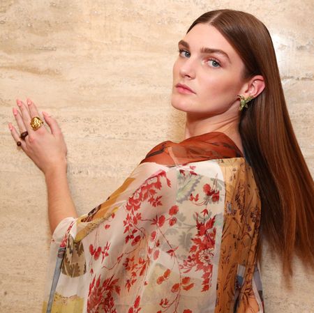 woman with long thick hair wearing a flowered shirt