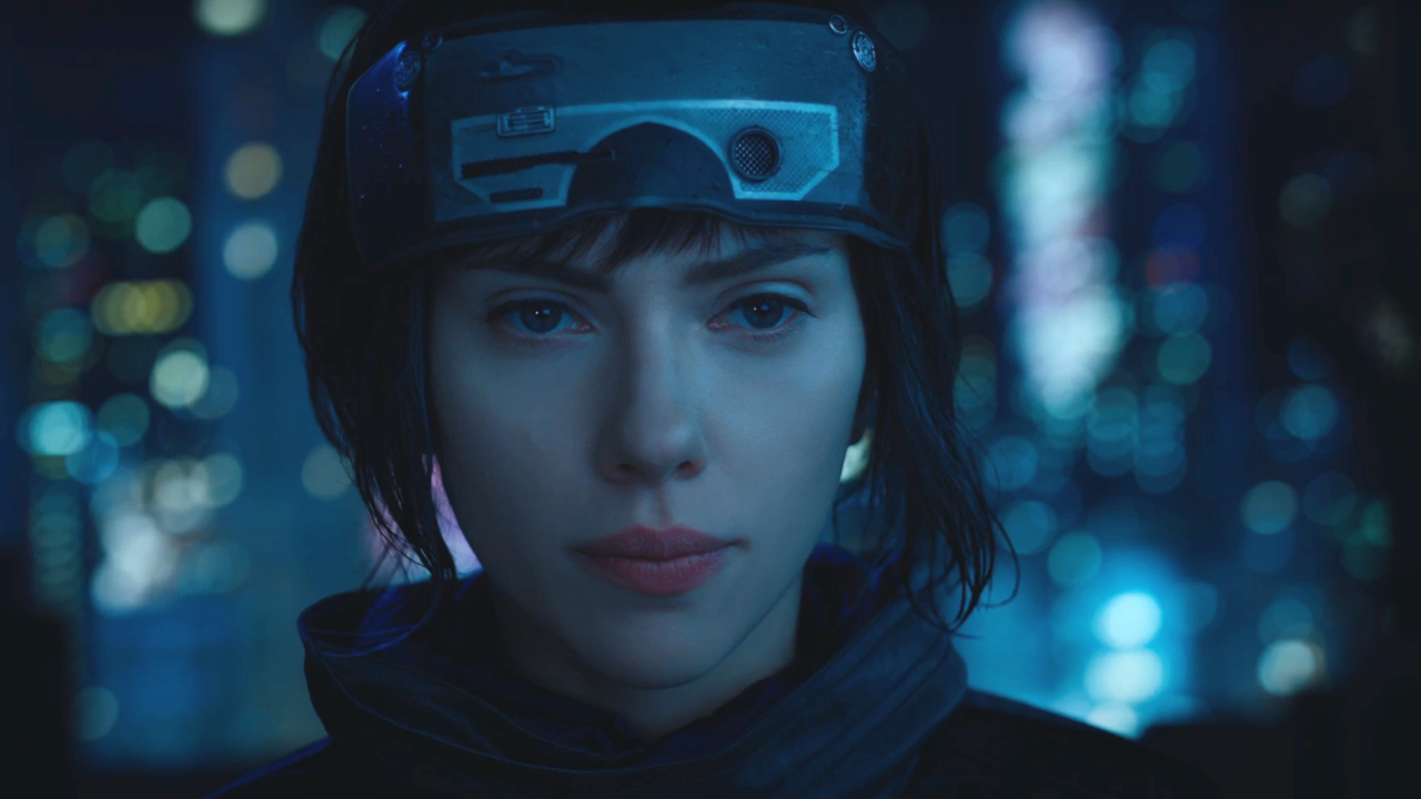 Scarlett Johansson looks focused while wearing a futuristic headset in Ghost in the Shell.