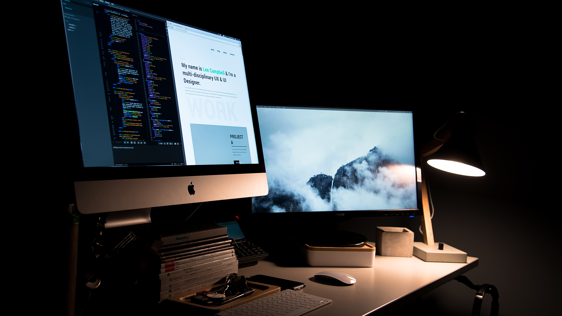 two screens on a desk showing different webpages