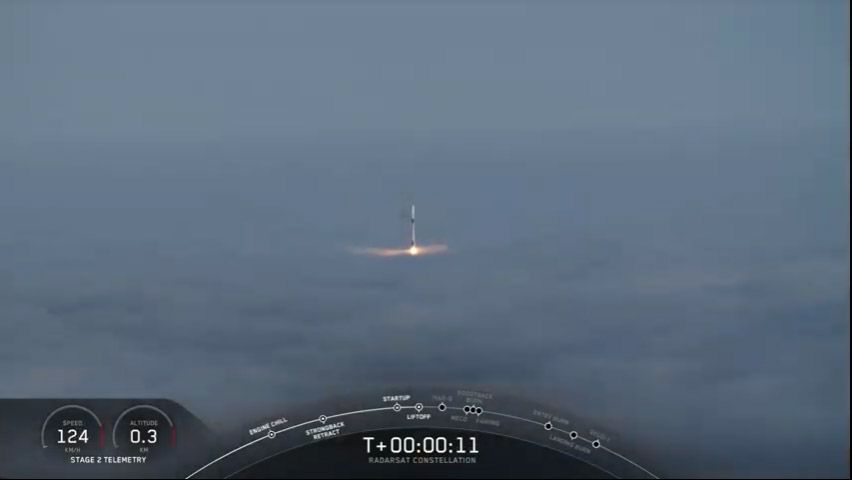 A SpaceX Falcon 9 rocket carrying three Canadian Radarsat Earth-observation satellites emerges above thick fog as it launches into orbit from Vandenberg Air Force in California on June 12, 2019.