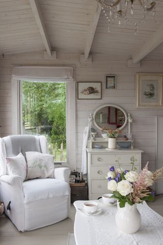 White armchair and coffee table in summerhouse
