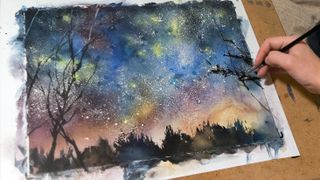 Erase the masking fluid to reveal a starry sky