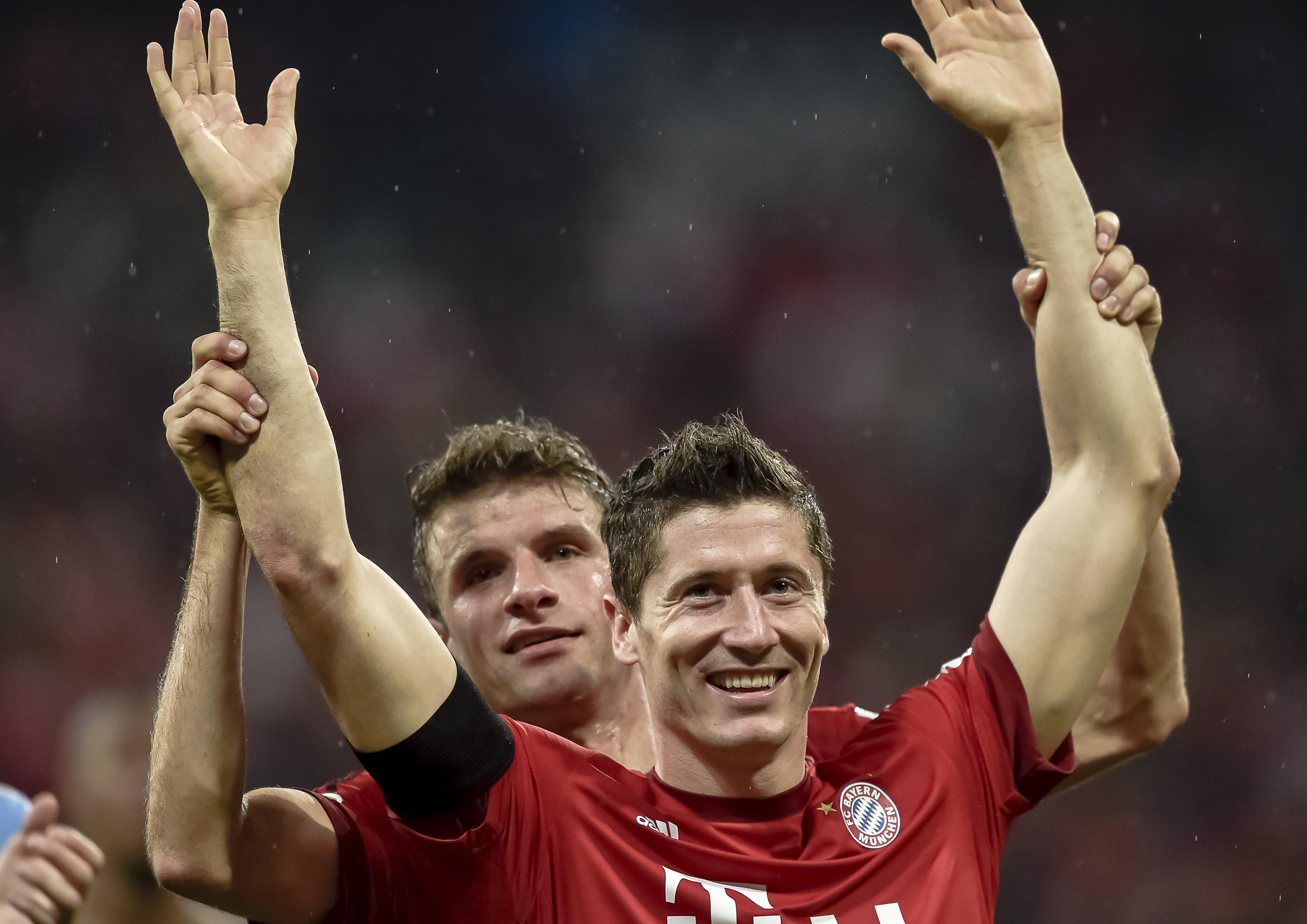 Robert Lewandowski celebrates with Thomas Muller after scoring five goals for Bayern Munich against Wolfsburg in September 2015.