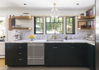 A kitchen with marble countertops, dark cabinetry, and a steel dishwasher