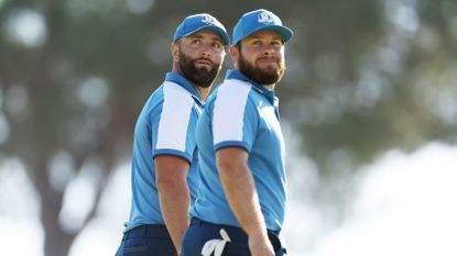 Tyrrell Hatton and Jon Rahm of Team Europe look on on the 15th green during the Friday morning foursomes matches of the 2023 Ryder Cup at Marco Simone Golf Club on September 29, 2023 in Rome, Italy.