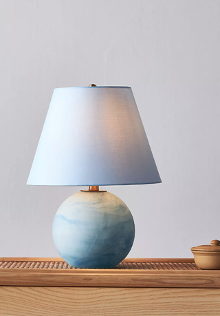 blue lamp with a swirling design on the base