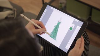 Someone drawing a green dress on an iPad (2021)