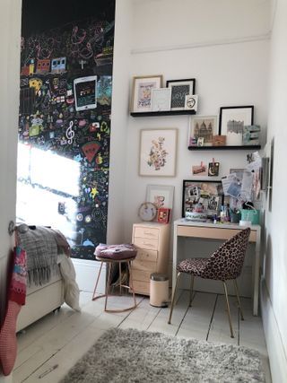 teen bedroom with stylish leopard office chair, with a gray rug on a white floor, and a large chalkboard wall