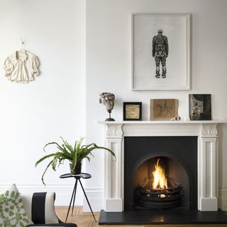 room with white wall and fireplace