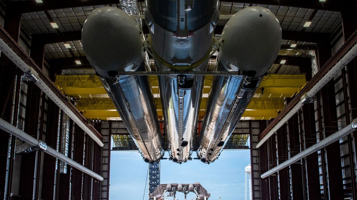 flacon heavy boosters in hangar with open door at the other side