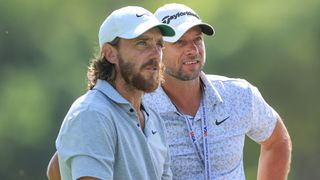 Photo of Tommy Fleetwood and a tour rep on course