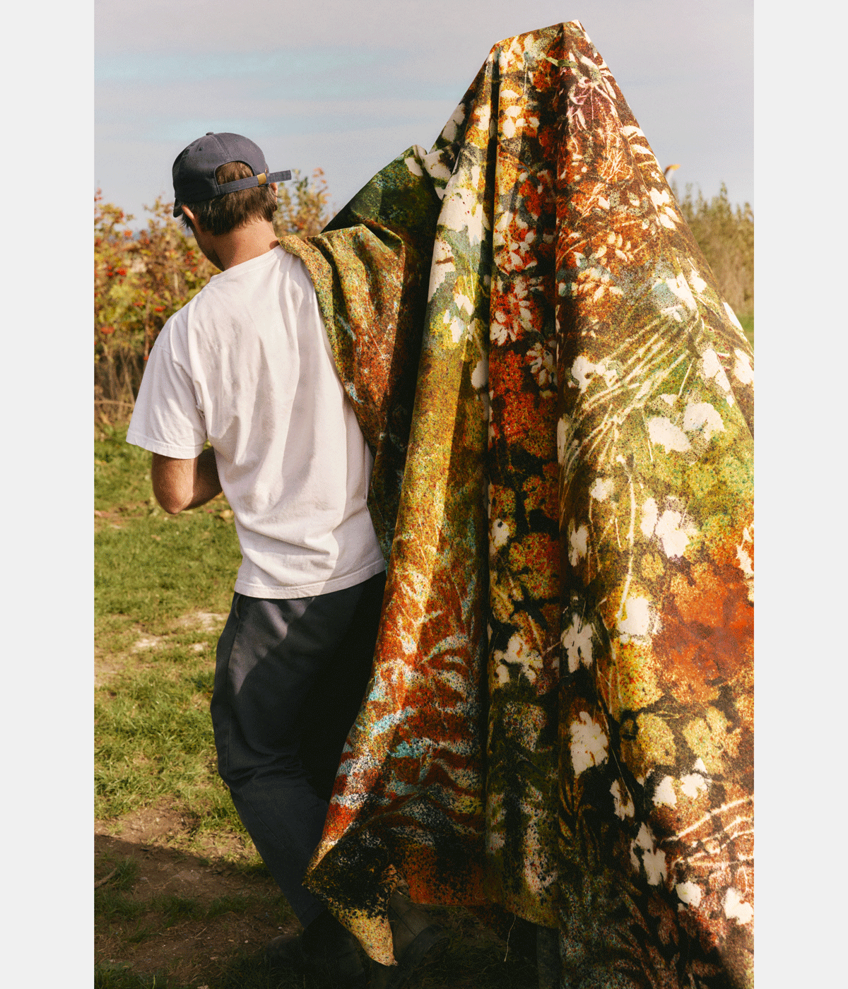man painting in a vineyard