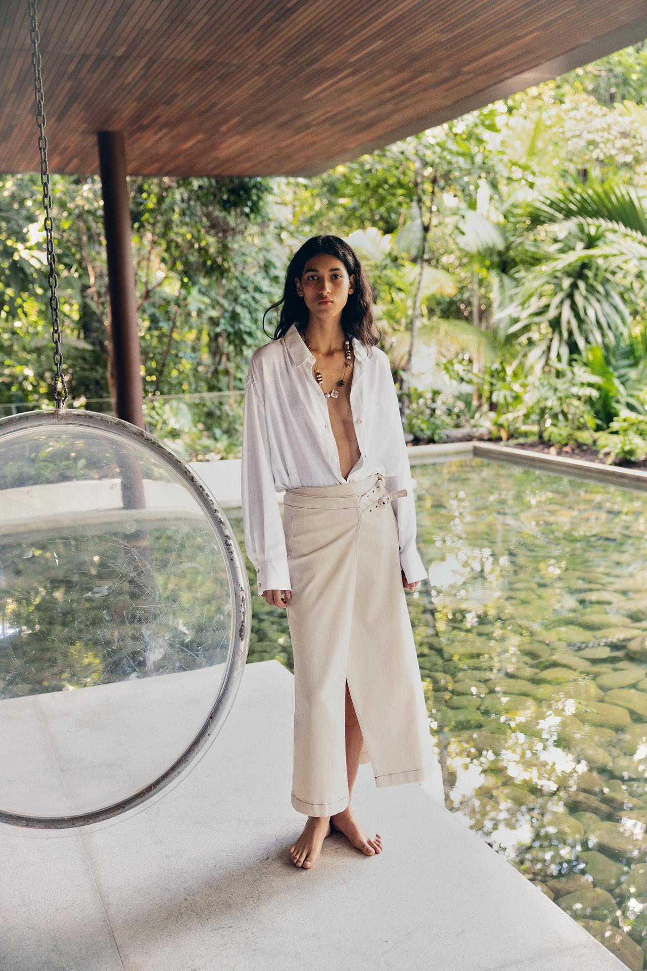 Model wearing a white skirt and skirt.